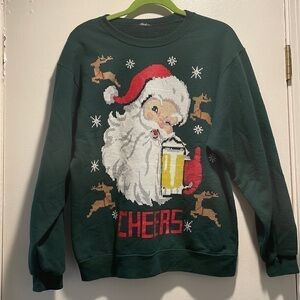𝅺Santa Faux Cross Stitch Sweatshirt Winking Drinking a Beer saying, “Cheers!”